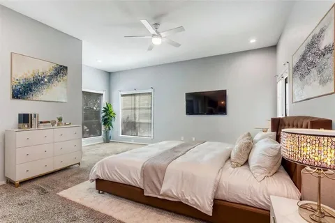 a bedroom with a large bed and a window