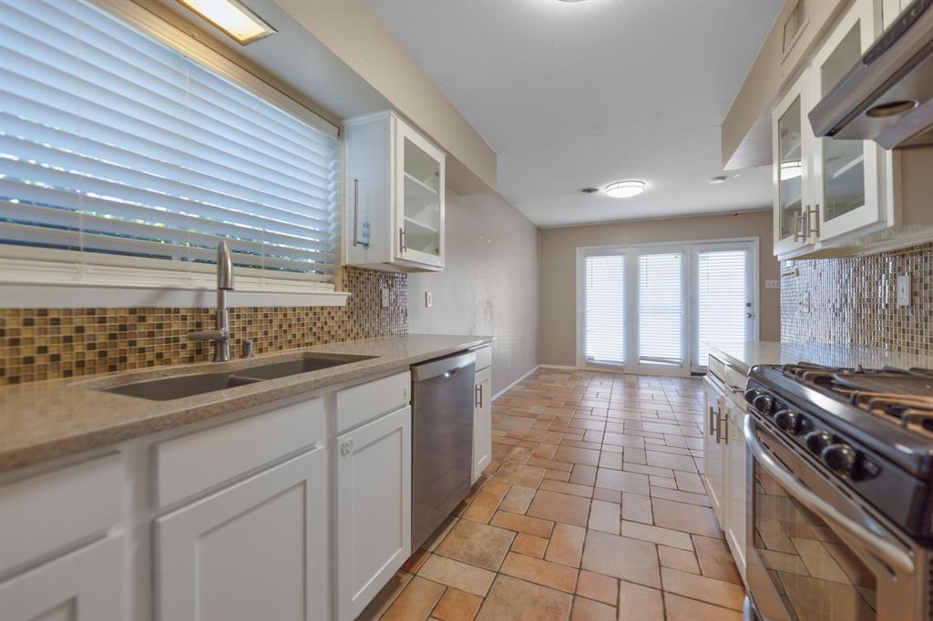 518 Worcester Way Richardson, TX 75080 - Photo 15 of 35 a kitchen with a sink stove and cabinets
