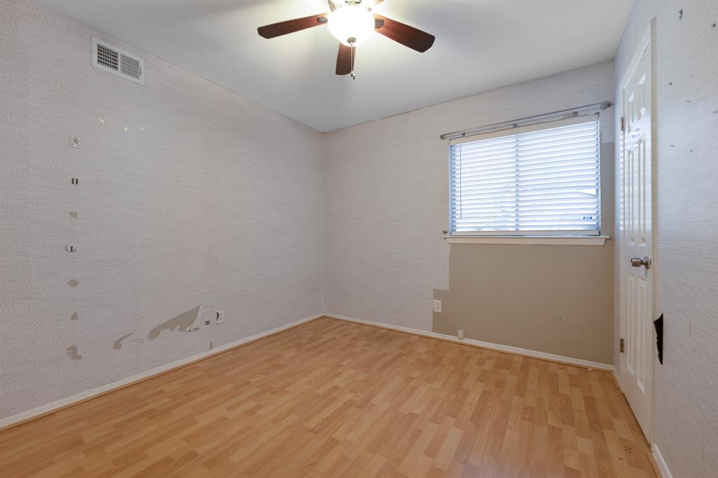 518 Worcester Way Richardson, TX 75080 - Photo 22 of 35 an empty room with a chandelier fan and windows