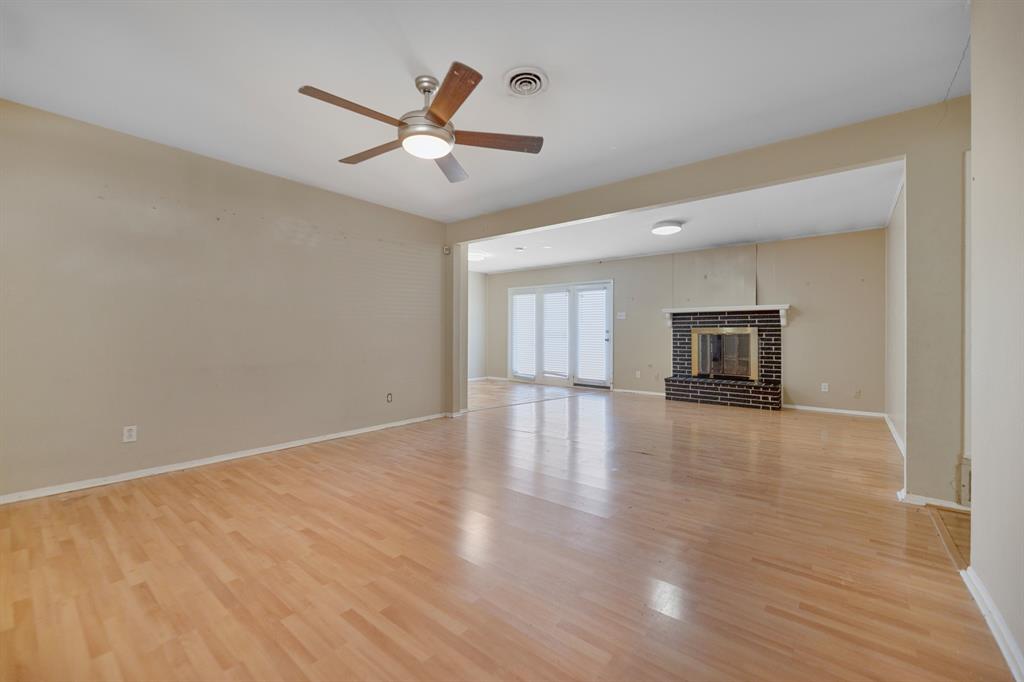 518 Worcester Way Richardson, TX 75080 - Photo 7 of 35 a view of empty room with wooden floor and ceiling fan