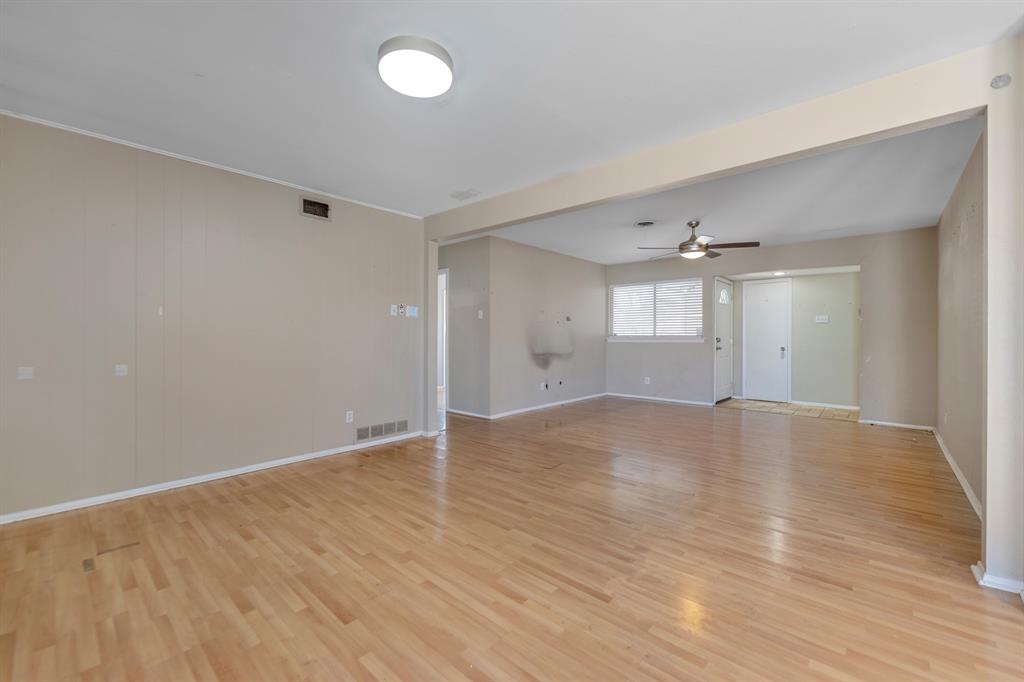 518 Worcester Way Richardson, TX 75080 - Photo 10 of 35 an empty room with wooden floor and windows