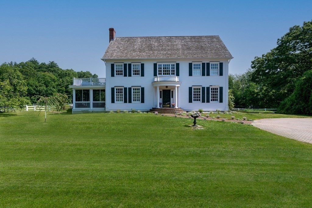154 Harvard Road Stow, MA 01775 - Photo 3 of 42 a front view of a house with a garden