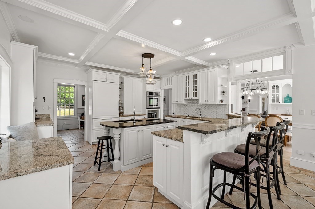 154 Harvard Road Stow, MA 01775 - Photo 5 of 42 a kitchen with cabinets and chairs
