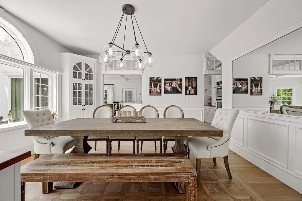 154 Harvard Road Stow, MA 01775 - Photo 9 of 42 a view of a dining room with furniture a chandelier and wooden floor