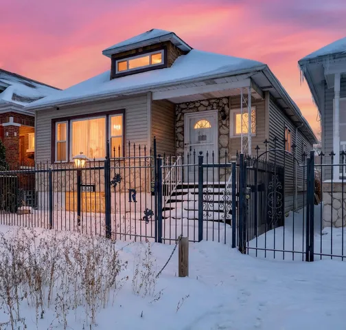 a view of a house with a wooden fence