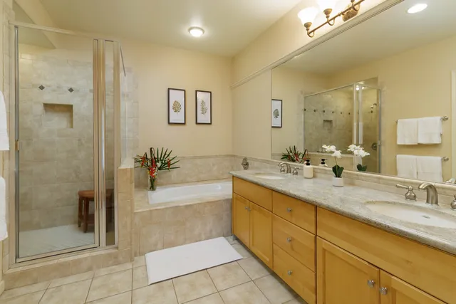 a bathroom with a granite countertop sink mirror and shower