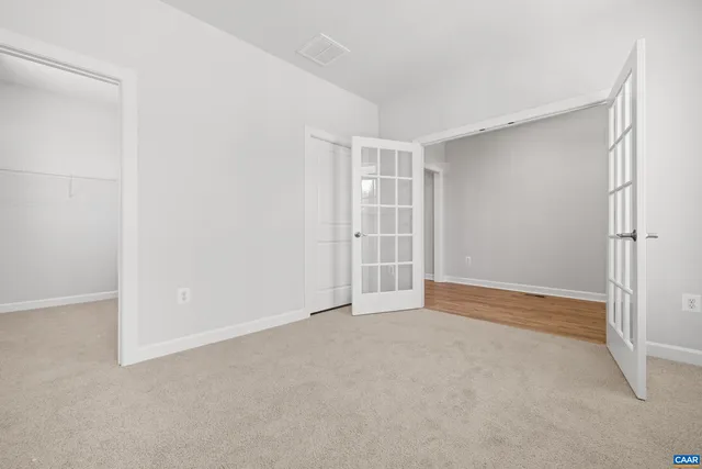 a bathroom with a granite countertop sink toilet mirror and bathtub