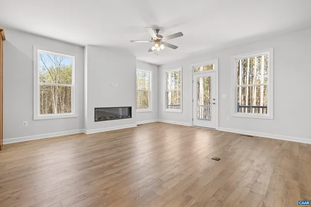 a living room with furniture a large window and a flat screen tv