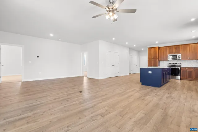a living room with furniture and kitchen view