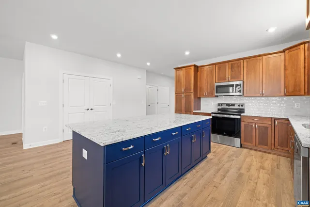 a kitchen with granite countertop a sink and a window