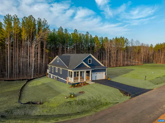 a aerial view of a house with swimming pool and big yard