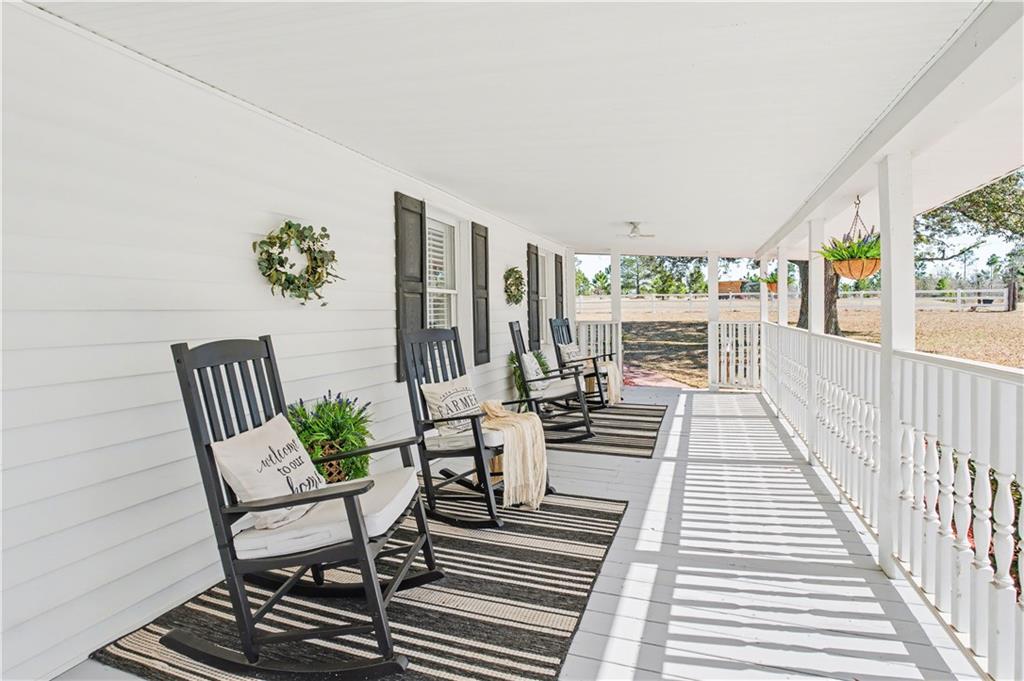 1833 Tom Odum Road Vidalia, GA 30474 - Photo 7 of 59 a view of a patio with table and chairs with wooden floor and fence
