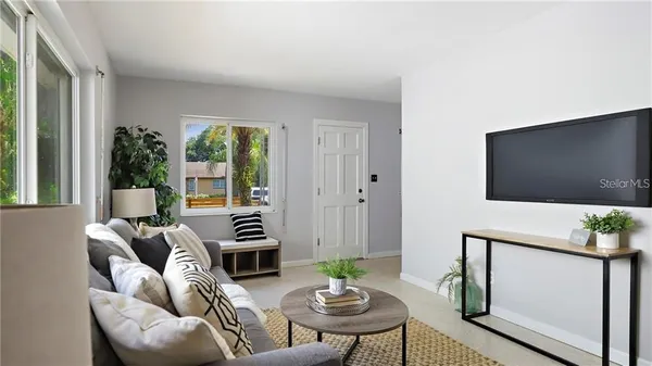 a living room with furniture and a flat screen tv