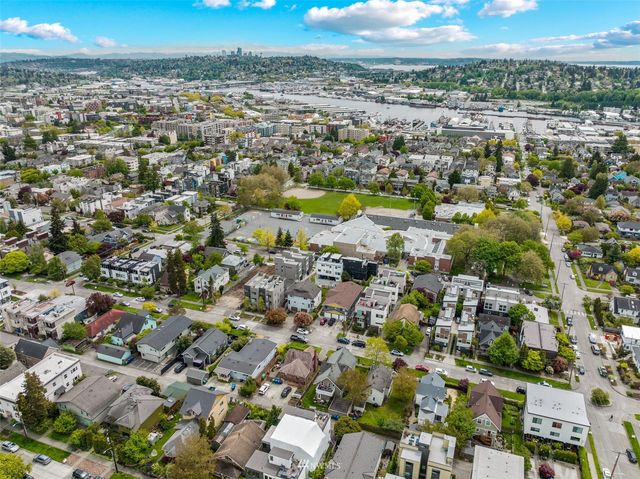 an aerial view of residential houses with city view