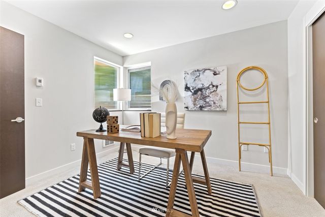 a view of a dining room with furniture and a window