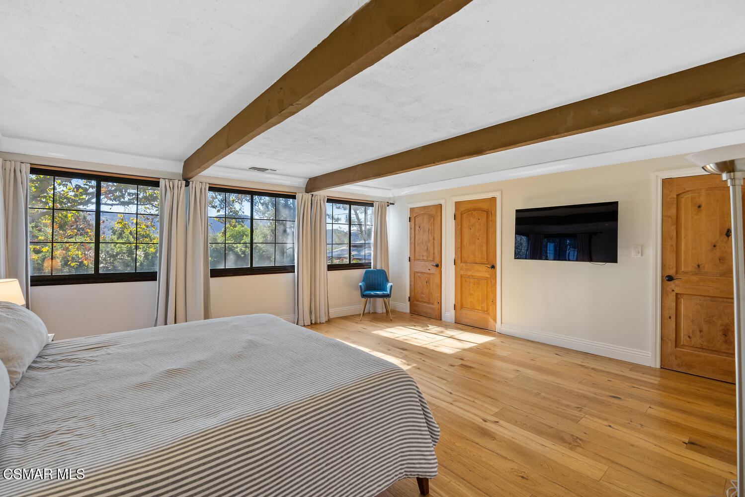 11316 Barranca Road Camarillo, CA 93012 - Photo 24 of 44 a bedroom with a large bed a flat tv screen and large window