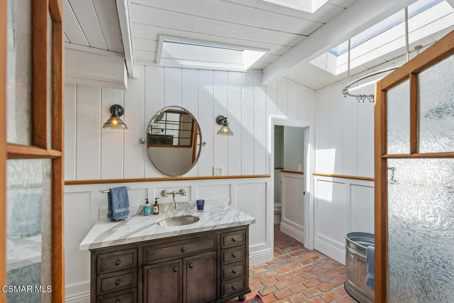 11316 Barranca Road Camarillo, CA 93012 - Photo 29 of 44 a bathroom with a double vanity sink and a mirror