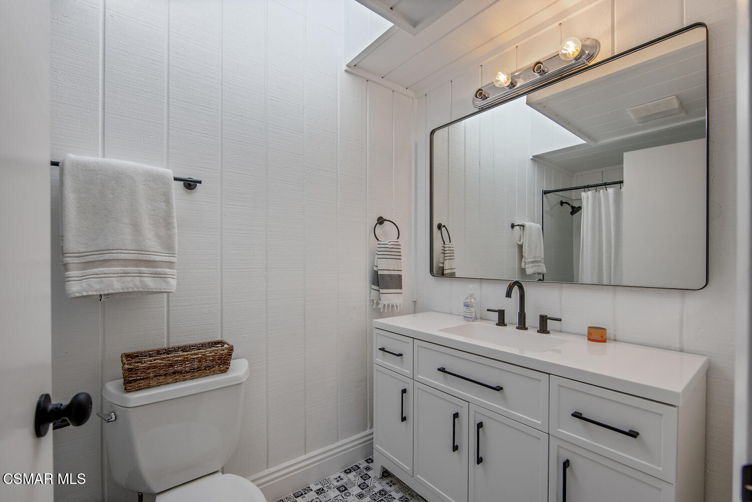 11316 Barranca Road Camarillo, CA 93012 - Photo 32 of 44 a bathroom with a sink a toilet and mirror