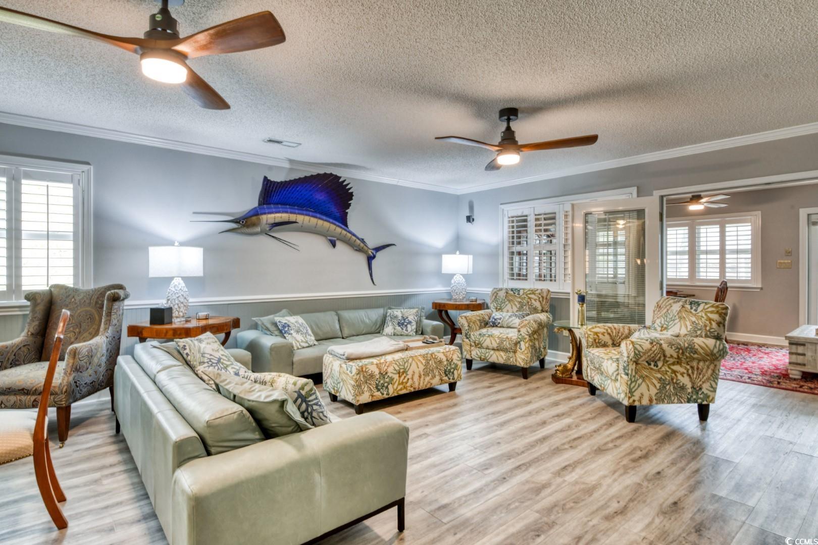 3714 Jordan Landing Road Murrells Inlet, SC 29576 - Photo 15 of 39 Living area featuring plenty of natural light, a ceiling fan, a textured ceiling, and ornamental molding