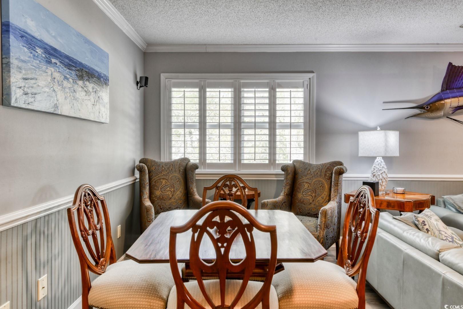 3714 Jordan Landing Road Murrells Inlet, SC 29576 - Photo 17 of 39 Dining room with a wainscoted wall, ornamental molding, and a textured ceiling