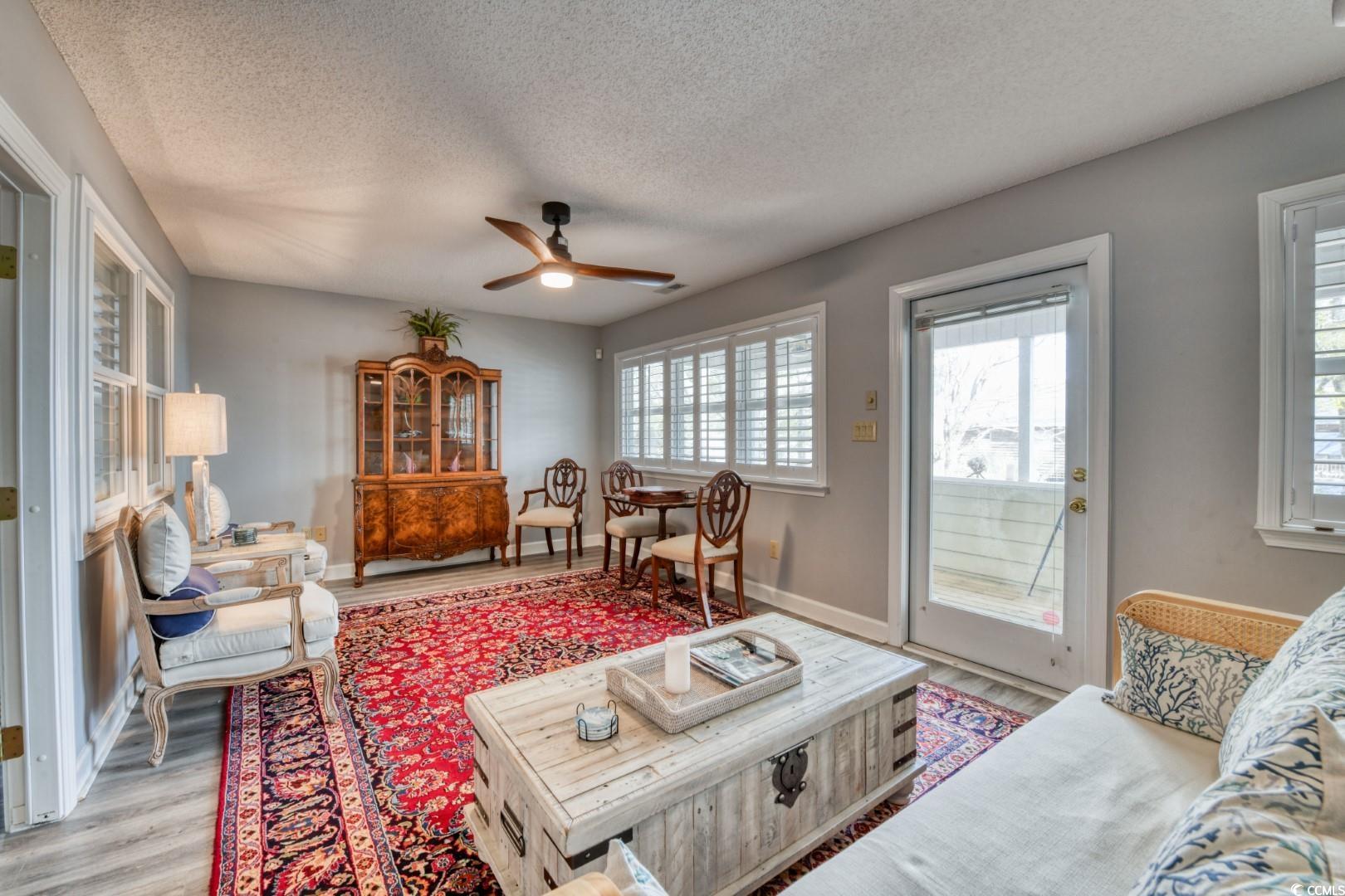 3714 Jordan Landing Road Murrells Inlet, SC 29576 - Photo 18 of 39 Living room featuring a textured ceiling, ceiling fan, and wood finished floors
