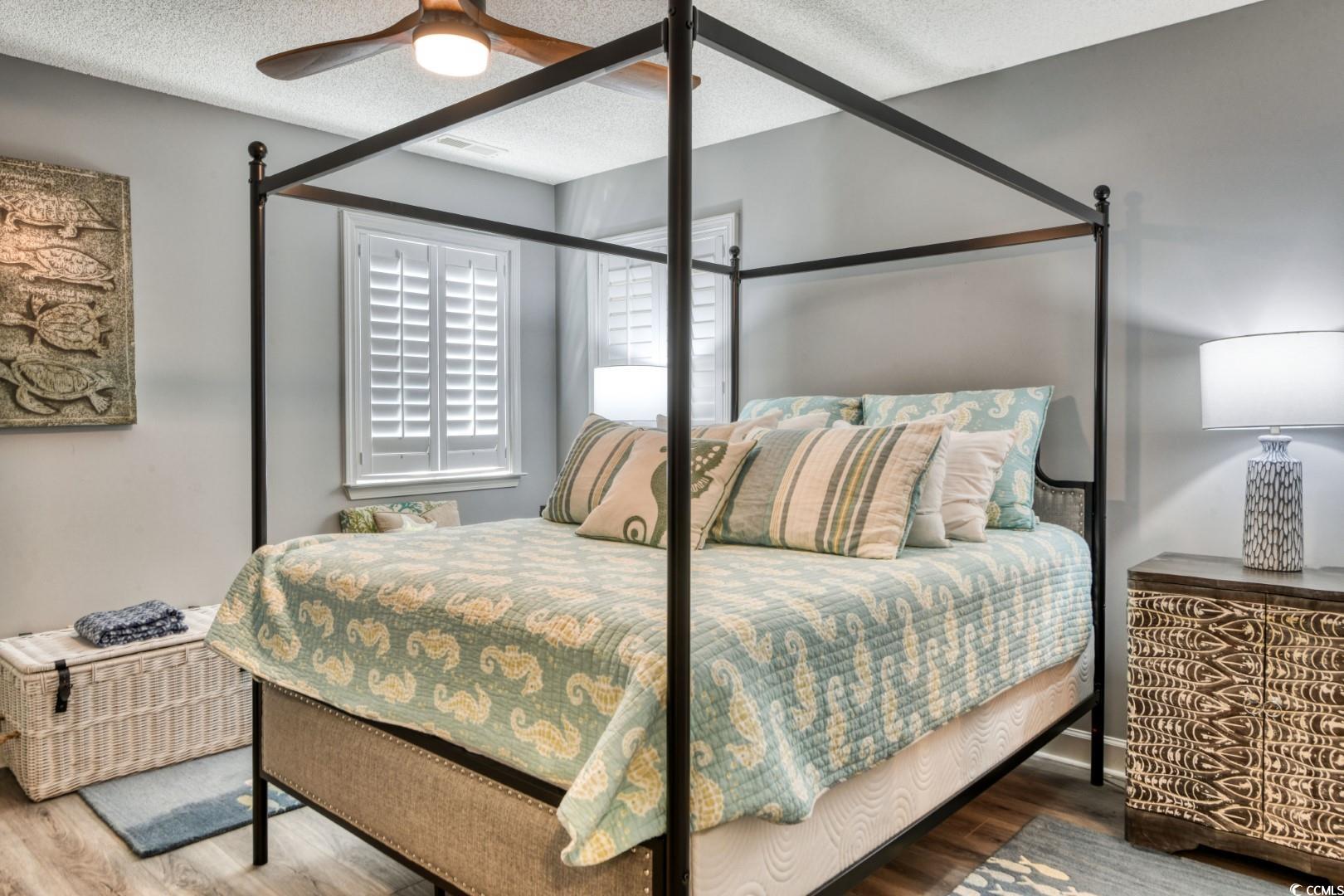 3714 Jordan Landing Road Murrells Inlet, SC 29576 - Photo 20 of 39 Bedroom featuring a textured ceiling, wood finished floors, and a ceiling fan