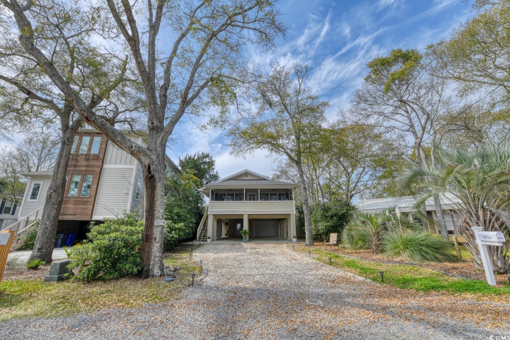 3714 Jordan Landing Road Murrells Inlet, SC 29576 - Photo 2 of 39 Beach home featuring stairs, driveway, a carport, a sunroom, and a deck