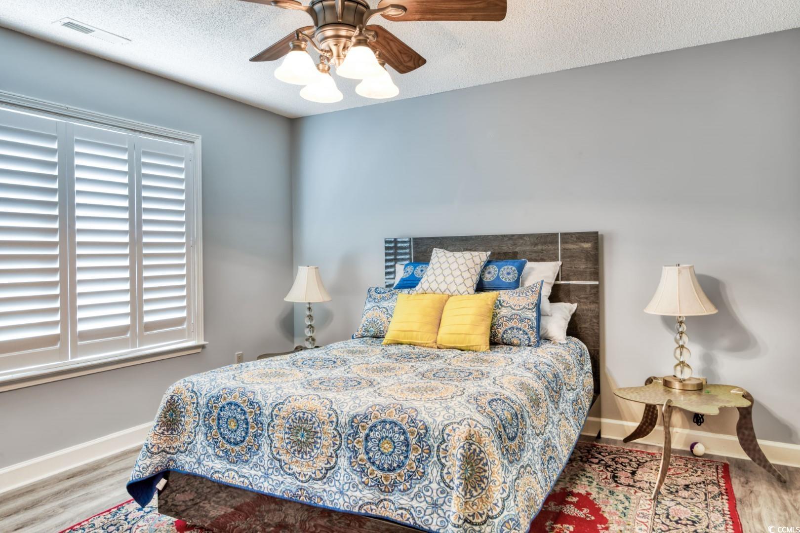3714 Jordan Landing Road Murrells Inlet, SC 29576 - Photo 23 of 39 Bedroom with wood finished floors, a textured ceiling, and a ceiling fan