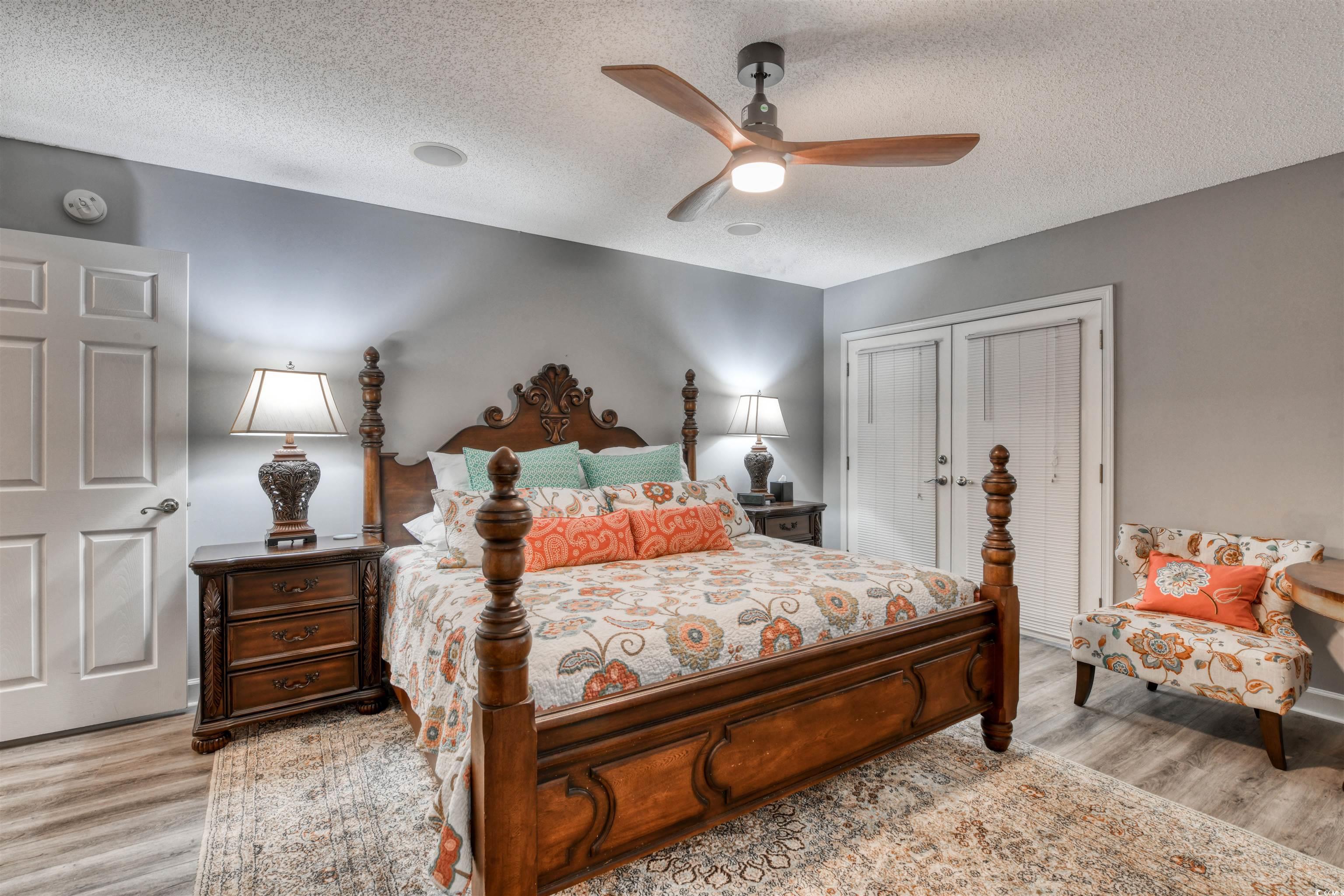 3714 Jordan Landing Road Murrells Inlet, SC 29576 - Photo 24 of 39 Bedroom with a textured ceiling, a closet, light wood-style flooring, and ceiling fan