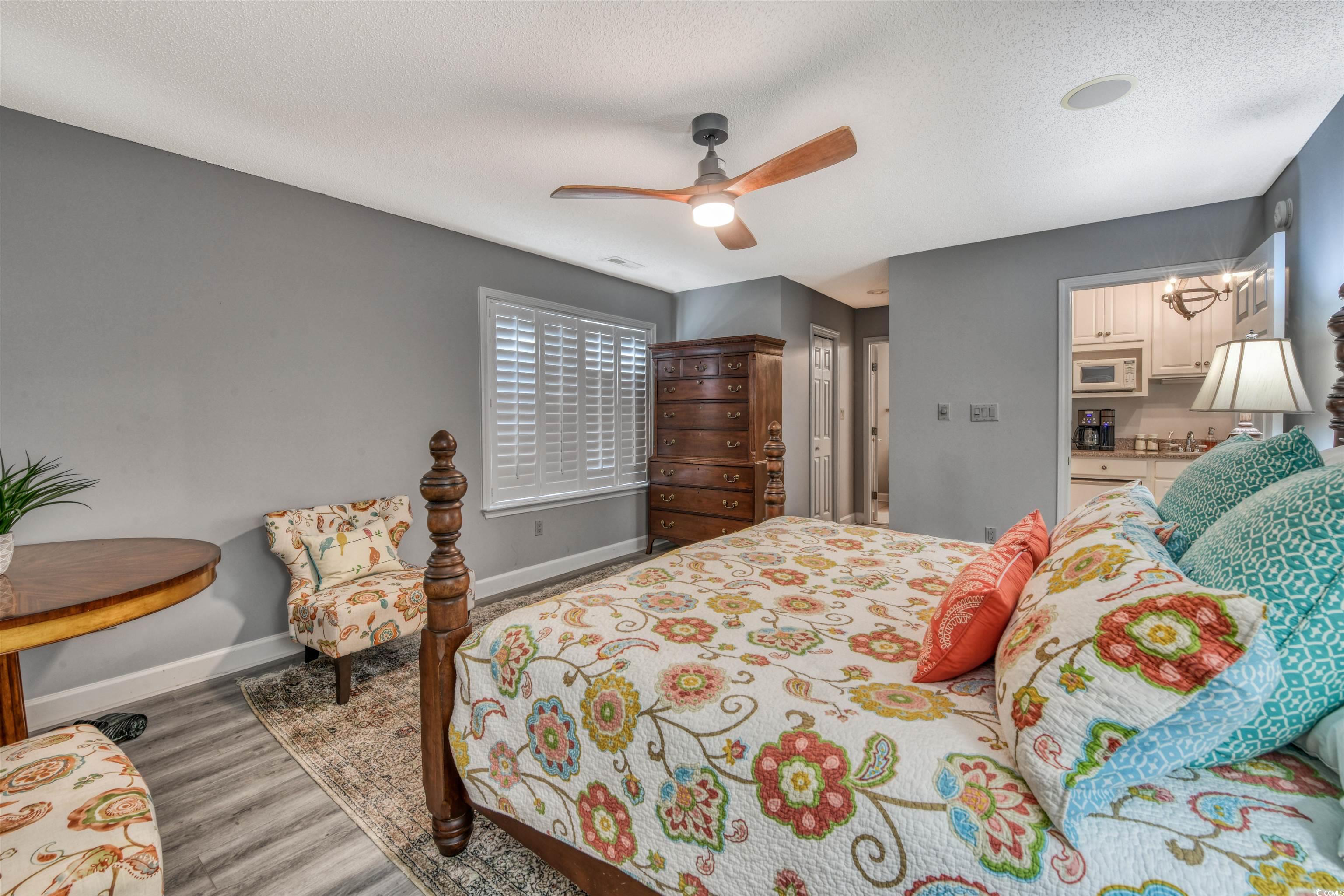3714 Jordan Landing Road Murrells Inlet, SC 29576 - Photo 25 of 39 Bedroom with a textured ceiling, a ceiling fan, and wood finished floors