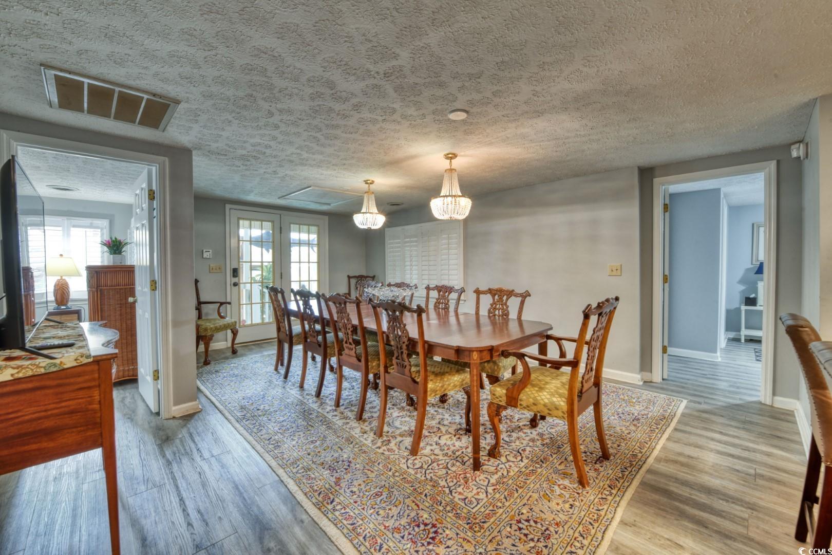 3714 Jordan Landing Road Murrells Inlet, SC 29576 - Photo 10 of 39 Dining space featuring a textured ceiling, light wood-style floors, and french doors