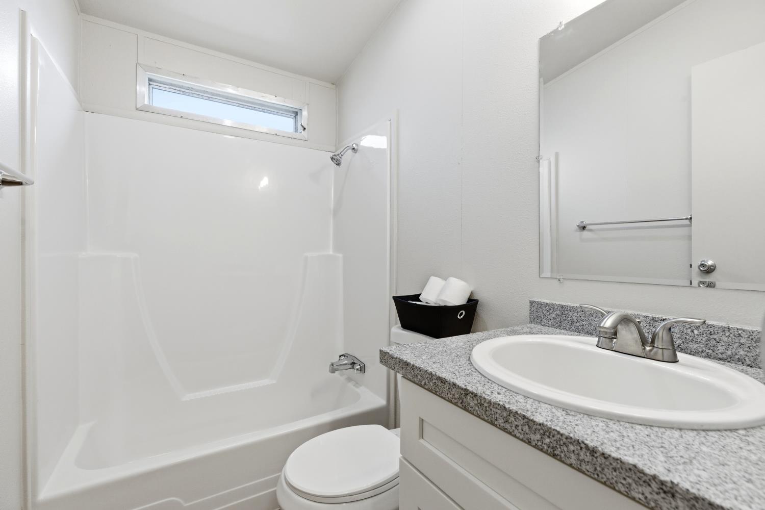 2307 Oakdale Road, Unit 15 Modesto, CA 95355 - Photo 12 of 17 a bathroom with a granite countertop sink toilet and shower