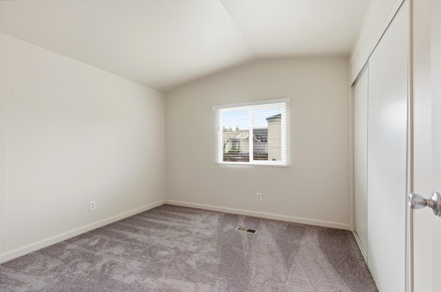 2307 Oakdale Road, Unit 15 Modesto, CA 95355 - Photo 13 of 17 an empty room with a window