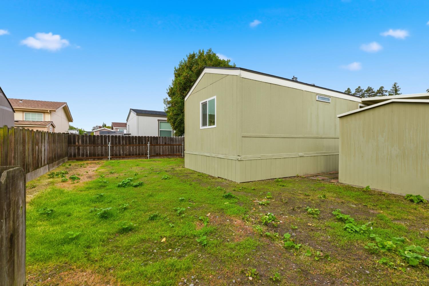 2307 Oakdale Road, Unit 15 Modesto, CA 95355 - Photo 16 of 17 a backyard of a house with lots of green space