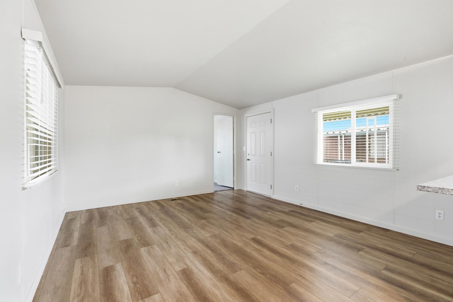 2307 Oakdale Road, Unit 15 Modesto, CA 95355 - Photo 8 of 17 a view of empty room with wooden floor and fan