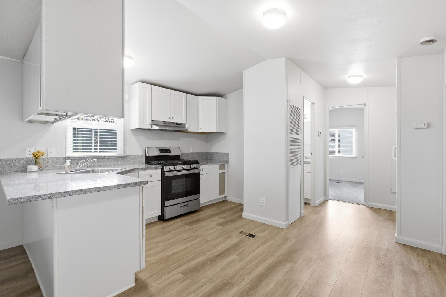 2307 Oakdale Road, Unit 15 Modesto, CA 95355 - Photo 9 of 17 a kitchen with granite countertop a sink cabinets and stainless steel appliances