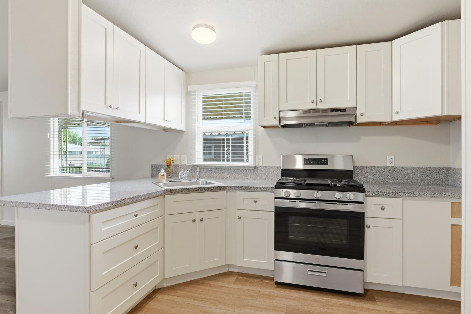 2307 Oakdale Road, Unit 15 Modesto, CA 95355 - Photo 10 of 17 a kitchen with cabinets appliances and a sink