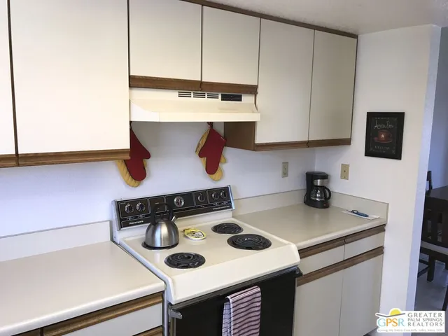 a kitchen with a stove and a table