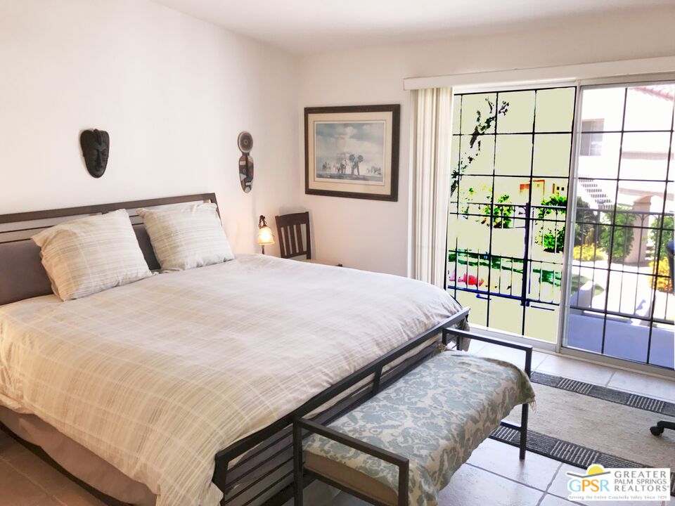 2701 East Mesquite Avenue, Unit GG180 Palm Springs, CA 92264 - Photo 12 of 26 a large bed sitting in a bedroom next to a window