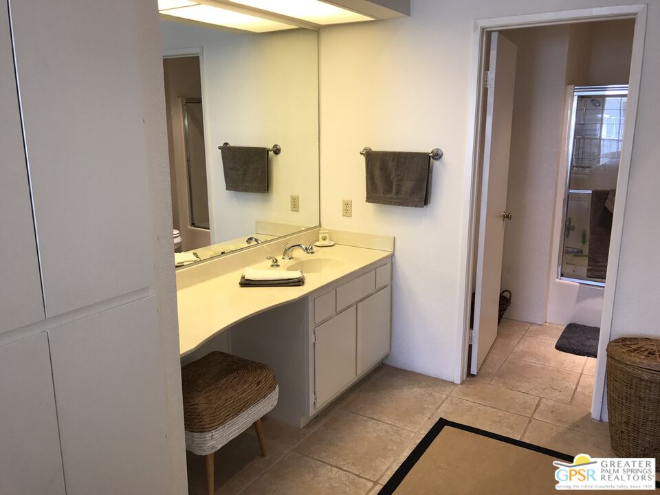 2701 East Mesquite Avenue, Unit GG180 Palm Springs, CA 92264 - Photo 15 of 26 a bathroom with a sink and a mirror