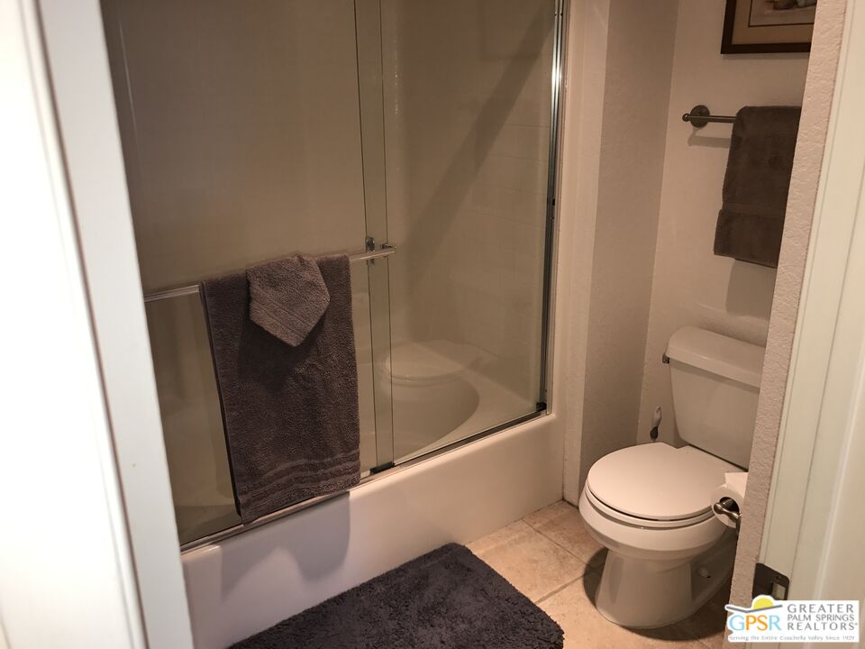 2701 East Mesquite Avenue, Unit GG180 Palm Springs, CA 92264 - Photo 16 of 26 a bathroom with a toilet and a shower