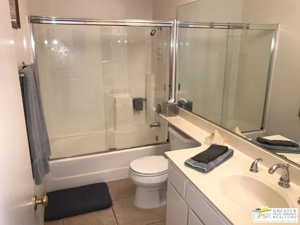 a bathroom with a sink a toilet and a shower