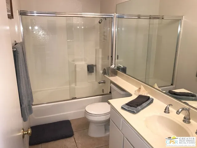 a bathroom with a sink a toilet and a shower