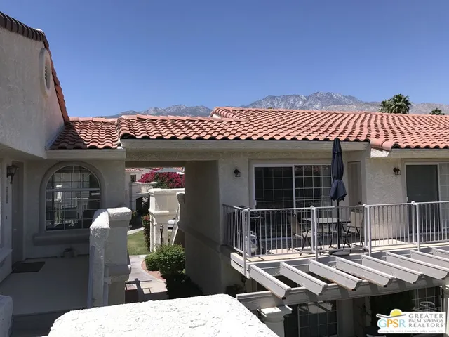 a view of a patio with table and chairs