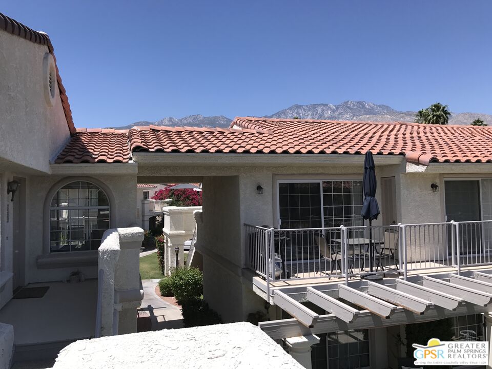 2701 East Mesquite Avenue, Unit GG180 Palm Springs, CA 92264 - Photo 22 of 26 a view of a patio with table and chairs