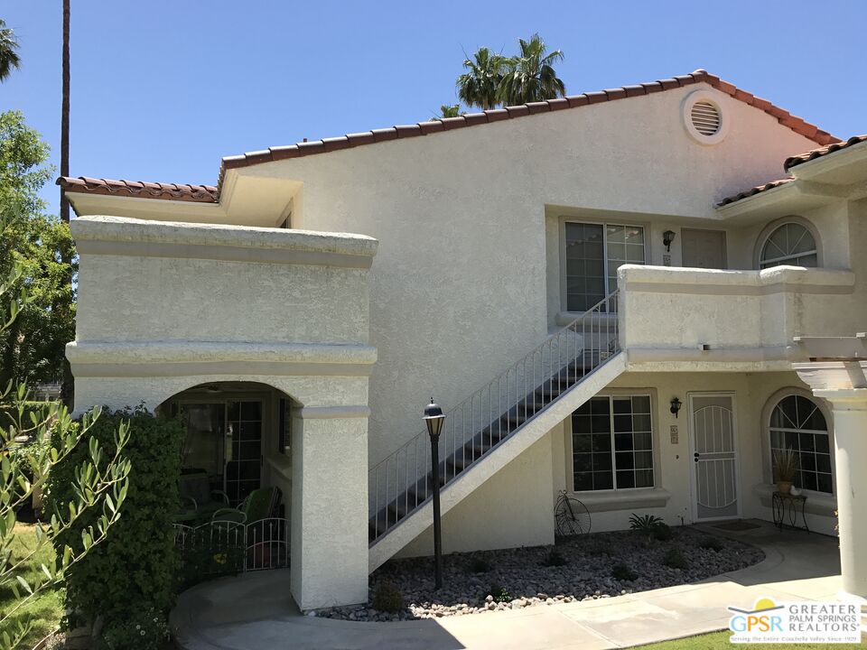 2701 East Mesquite Avenue, Unit GG180 Palm Springs, CA 92264 - Photo 24 of 26 a view of a white house with large windows