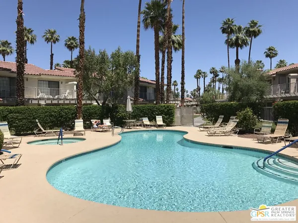 a view of a house with swimming pool and sitting area