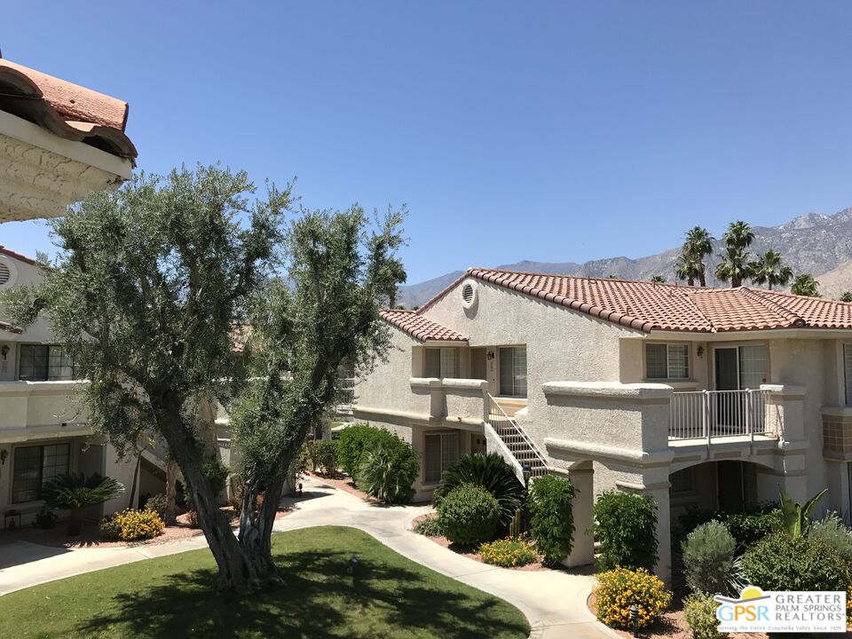 2701 East Mesquite Avenue, Unit GG180 Palm Springs, CA 92264 - Photo 5 of 26 a front view of a house with a garden