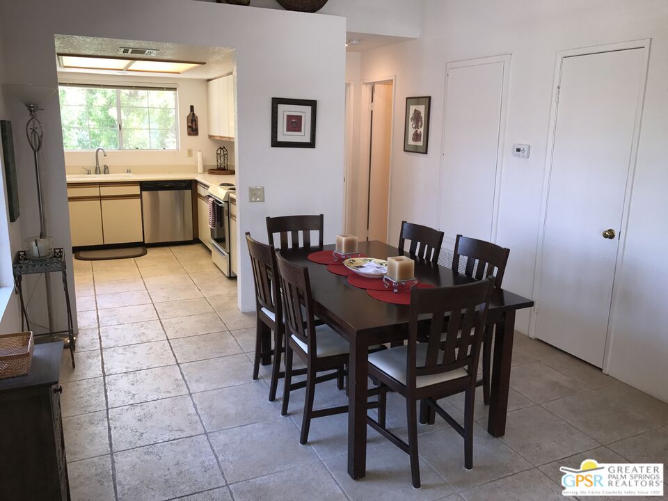 2701 East Mesquite Avenue, Unit GG180 Palm Springs, CA 92264 - Photo 8 of 26 a view of a dining room that has a table and chairs in it