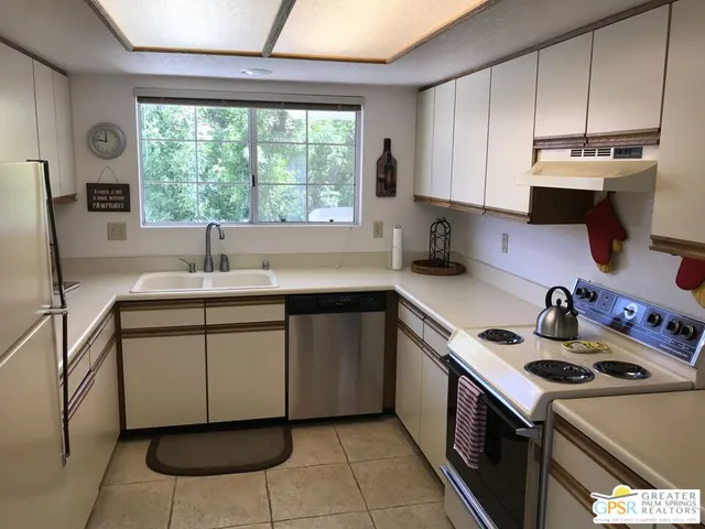 a kitchen with a sink cabinets and window